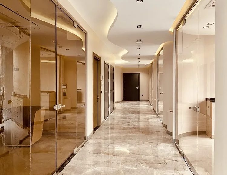 Bright corridor with glass partitions at our hair transplant clinic in Istanbul