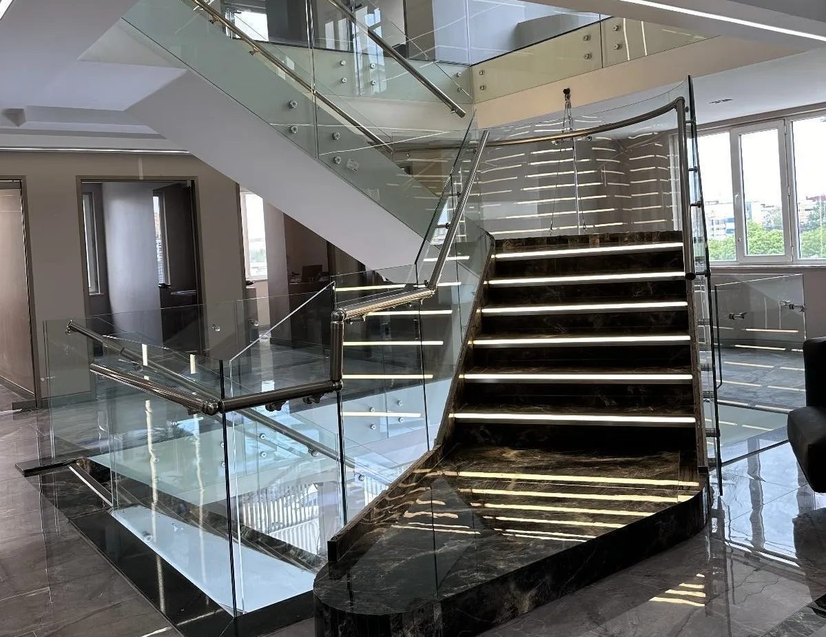 Glass staircase with illuminated steps inside the Global Health Hair clinic in Istanbul